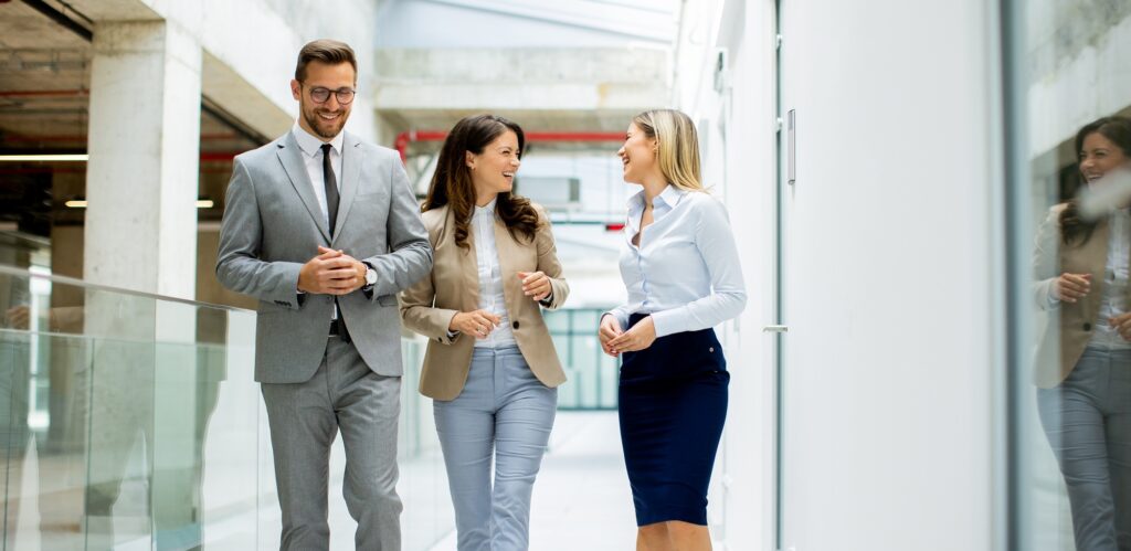 Young startup team have a discussion while walking in the modern office corridor